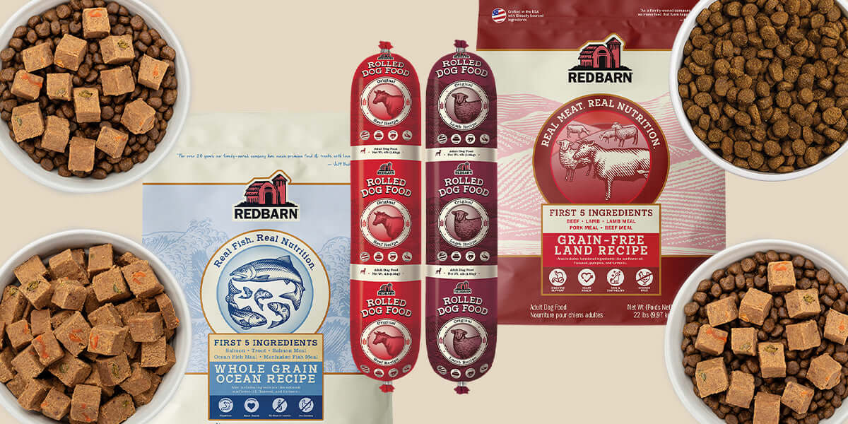 Red Barn pet food packaging and ingredients arranged on a beige background, including dog food bags, kibble bowls, and sausage-style canned foods. The layout shows multiple product variants with visible Red Barn branding.