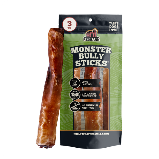 A pack of Red Barn Monster Bully Sticks dog treats, featuring a green and black resealable pouch with a single chew stick displayed vertically next to it on a plain white background.