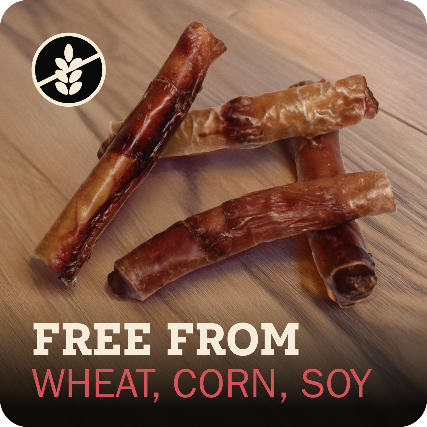 Four Redbarn Monster Bully arranged on a wood surface, with a black circular wheat-free icon in the top left and text at the bottom reading 'FREE FROM WHEAT, CORN, SOY'.