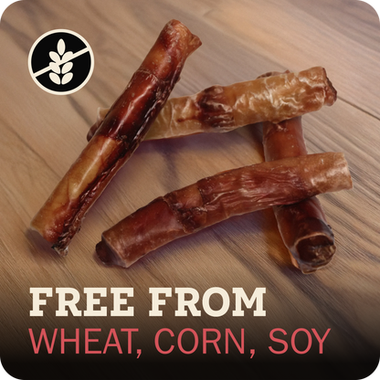 Four Redbarn Monster Bully arranged on a wood surface, with a black circular wheat-free icon in the top left and text at the bottom reading 'FREE FROM WHEAT, CORN, SOY'.