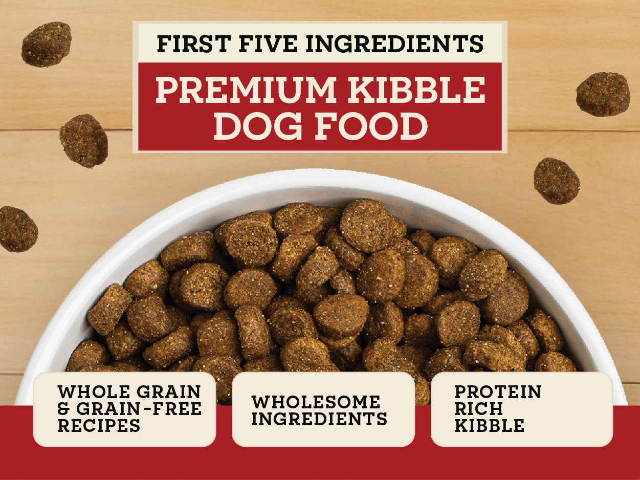 Dog food bowl with premium kibble and a label detailing ingredients on a wooden background