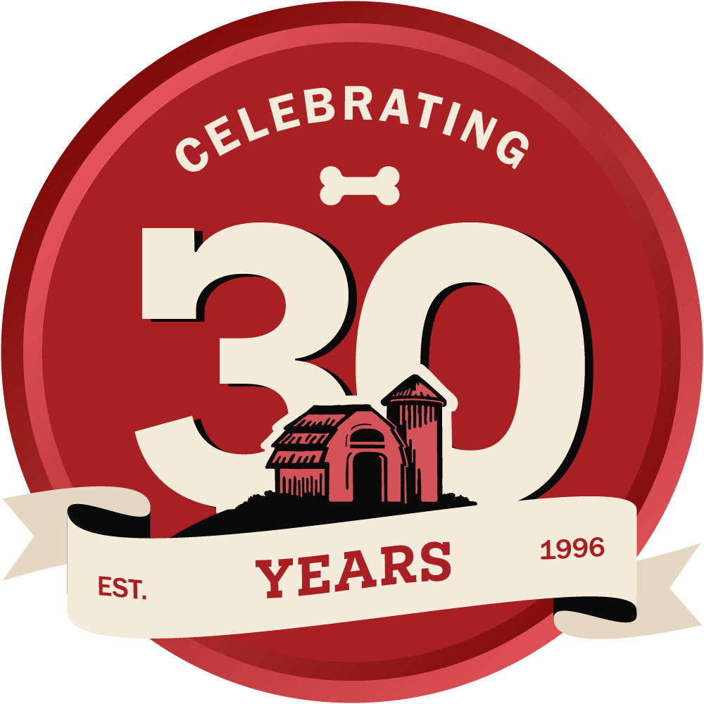 Logo celebrating 30 years with a barn building and '1996' on a red background
