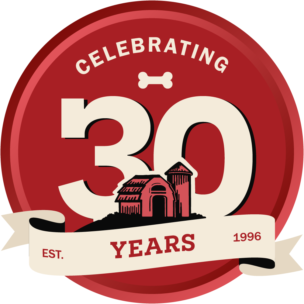 Logo celebrating 30 years with a barn building and '1996' on a red background