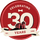 Logo celebrating 30 years with a barn building and '1996' on a red background